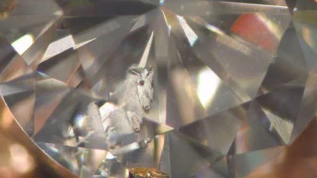 Close-up of a diamond showing feather inclusion pattern
