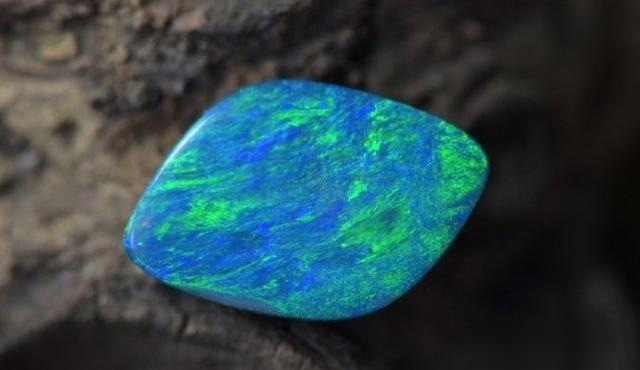 Doublet opal with host rock base, showing the natural layered structure.
