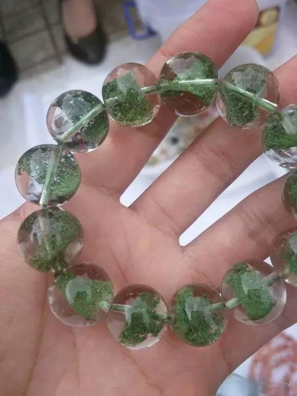 Imitation green phantom quartz bracelet made with artificially dyed or layered quartz beads to mimic natural inclusions.