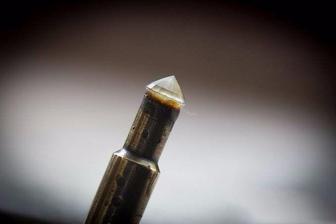 First layer of polishing completed on the gemstone, revealing a noticeable improvement in clarity and shine