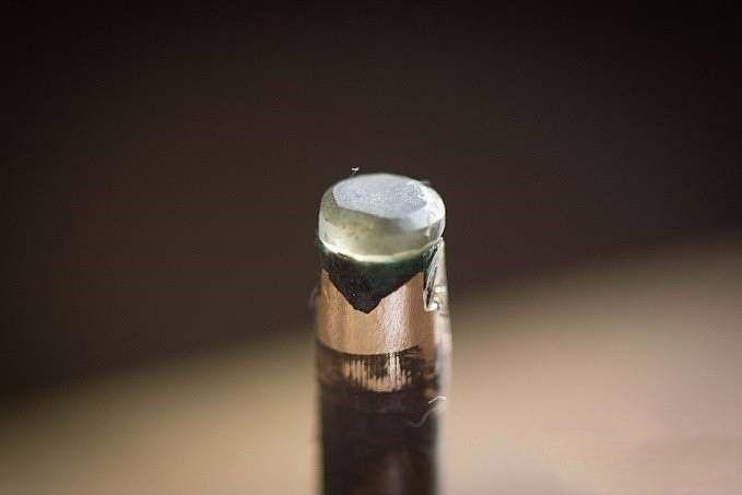 Gemstone securely positioned on the copper dop stick, ready for precise gemstone cutting