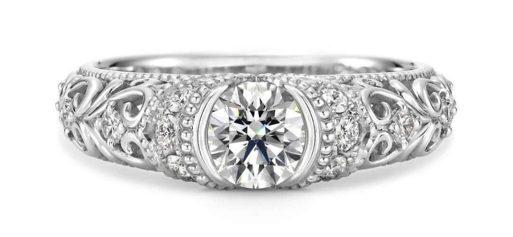 A half-bezel diamond ring, showcasing a unique setting that provides both security and light exposure for the diamond.