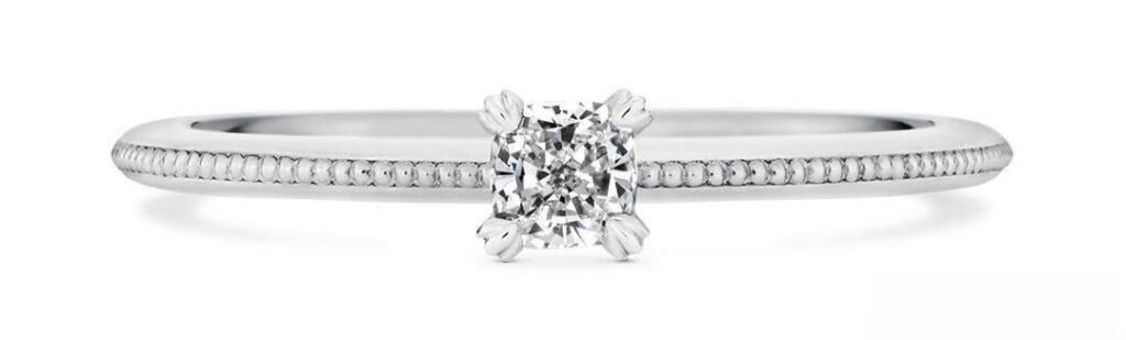 A ring featuring a heart-shaped prong setting design, with the gemstone securely held by prongs in a romantic heart shape, creating a unique and elegant look.