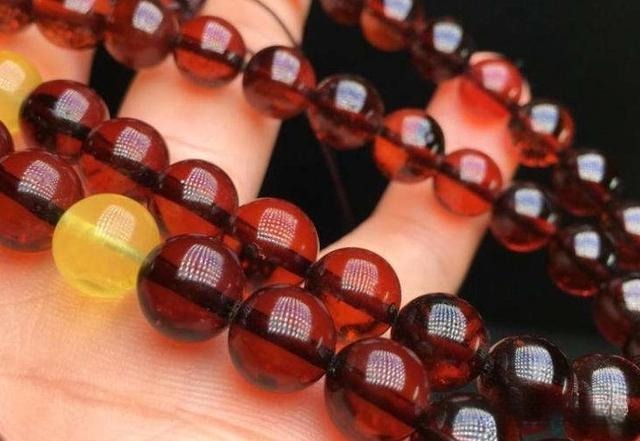 Heat-treated blood amber bead necklace, featuring beads enhanced to achieve a deep red color, commonly referred to as artificially colored amber.