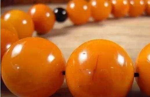 Close-up of heat-treated old wax amber bead bracelet, showing the warm color and texture achieved through gentle heat treatment.