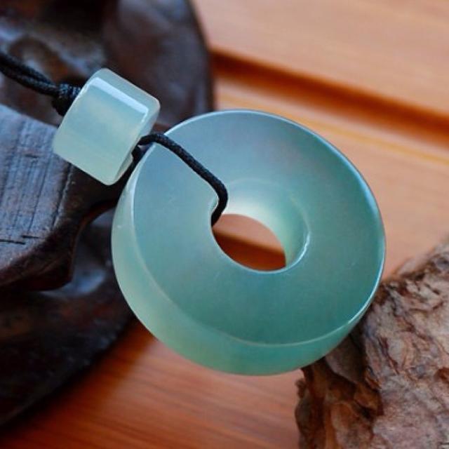 Icy jade pendant in oil green color with brilliant transparency, finely carved and polished — a stunning natural jade jewelry piece.