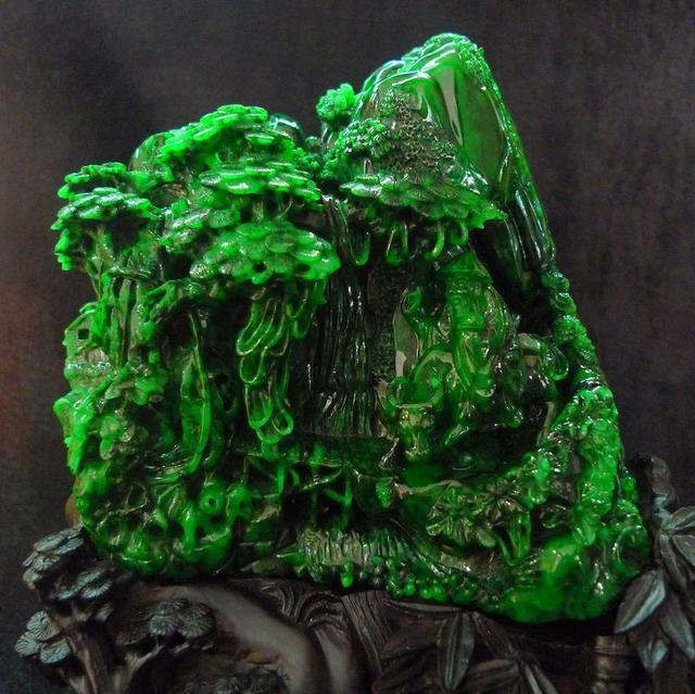 Mountain-shaped jadeite carving with smooth texture and natural green hues, a stunning decorative piece of natural jade.