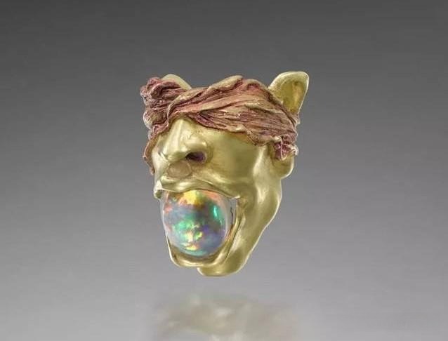 Gold ring featuring a lion head with opal, showcasing bold, dark-romantic design and meticulous craftsmanship