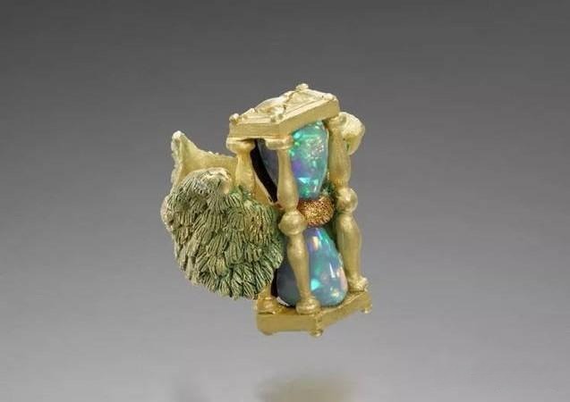 Kevin Coates gold ring featuring a vibrant opal, showcasing artistic craftsmanship and dark-romantic design