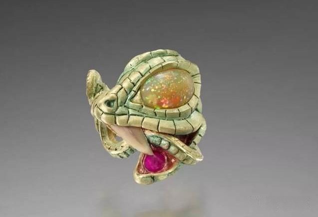 Ring featuring a serpent design with opal, showcasing dark-romantic style and intricate artistic craftsmanship