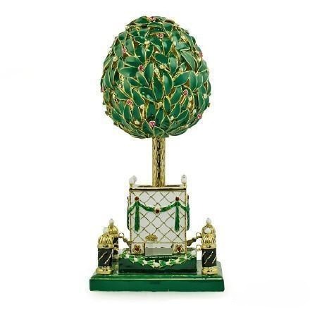 Fabergé laurel tree egg featuring vivid emerald green enamel leaves and gemstone "fruits," showcasing intricate mechanical and artistic craftsmanship.