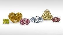 Loose fancy colored diamonds showcasing a range of vibrant yellow, pink, and blue gemstones – Gemstone Jewelry Buying Tips.