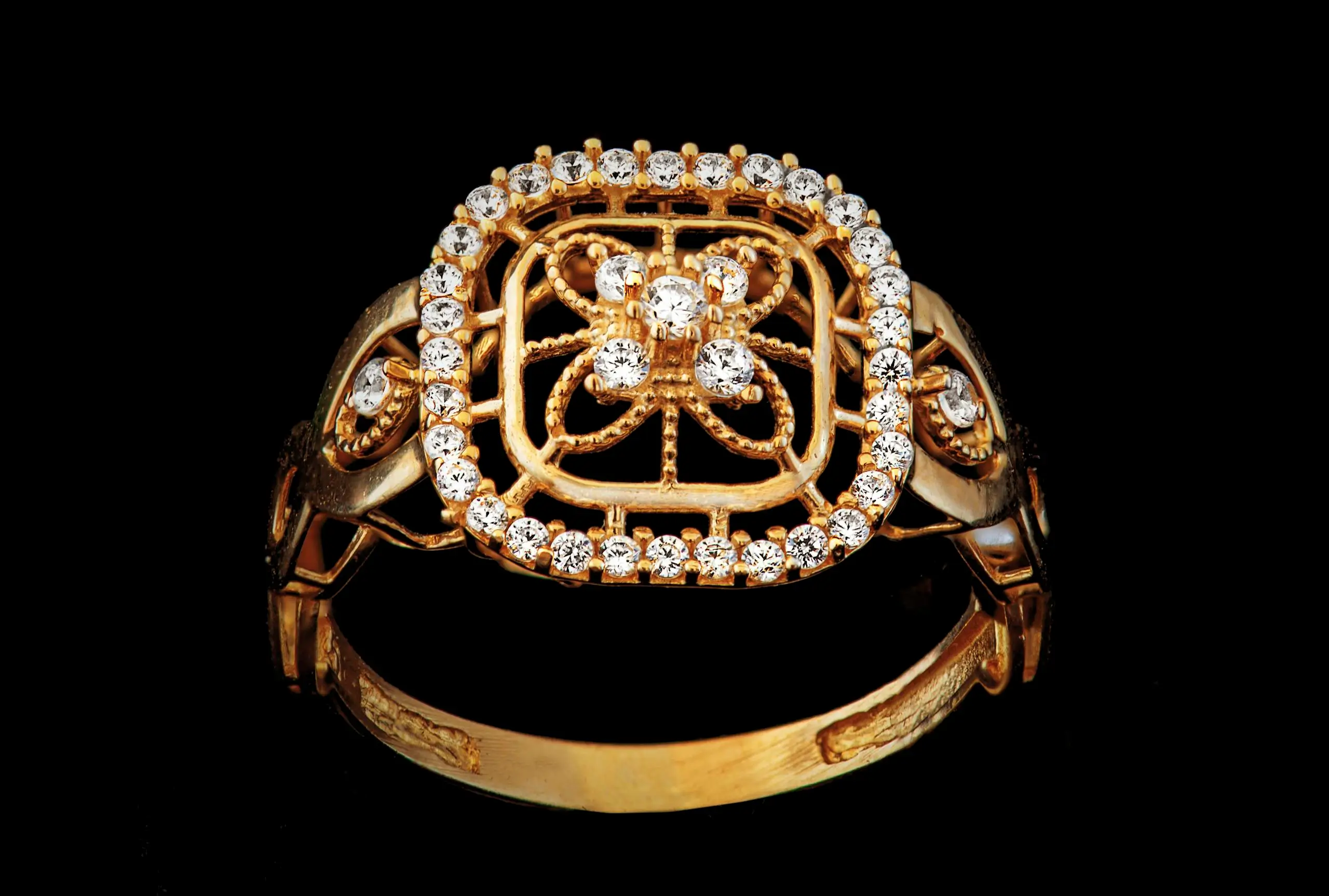 Luxurious gold ring adorned with glittering black diamonds, symbolizing mystery and elegance.