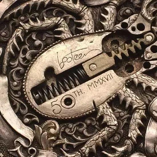 Close-up of the mechanical beetle coin mechanism showing gears, springs, and the intricate opening wing structure