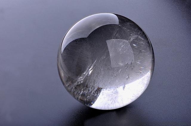 Natural quartz crystal showing cotton-like inclusions inside the stone.