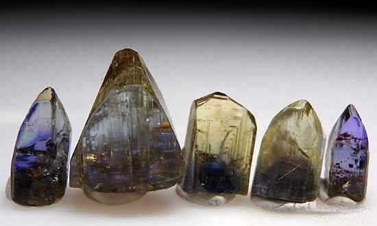 Natural rough Tanzanite showing gray and brown hues, along with common bluish-green, yellow, green, and light pink shades