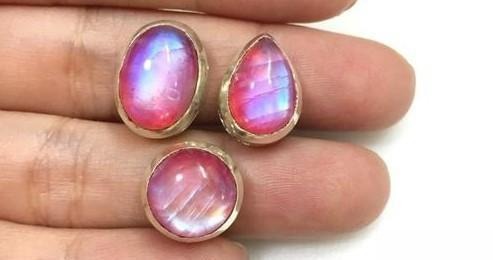 Jewelry featuring pink moonstone showing soft pink shimmer, highlighting color-enhancing backing.