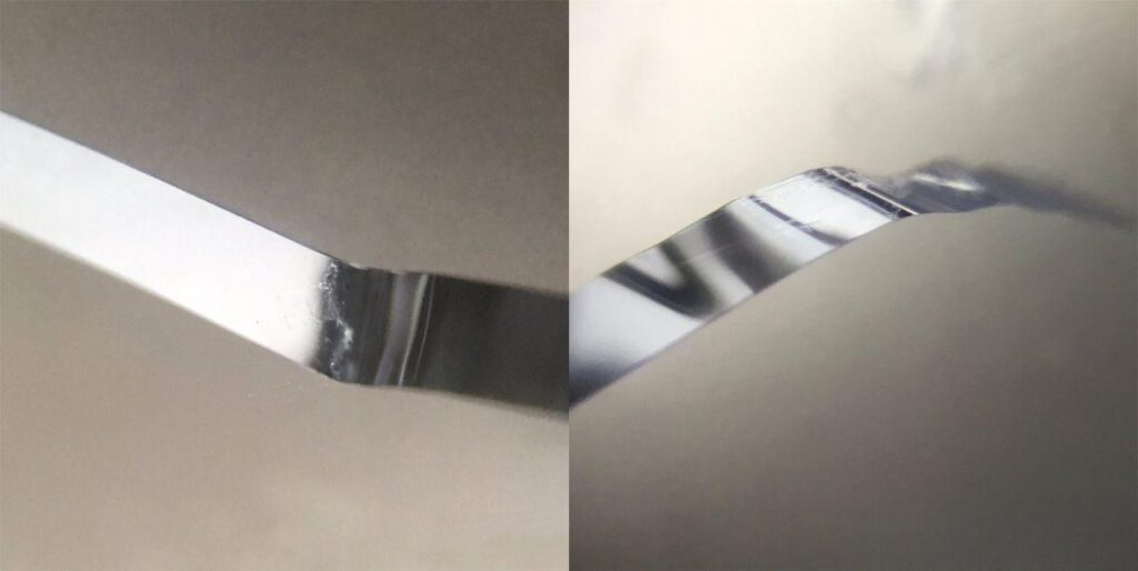 Microscopic view of quartz crystal showing smooth bismuth-lead wire-like inclusions from multiple angles, polished like a mirror unlike steel wool