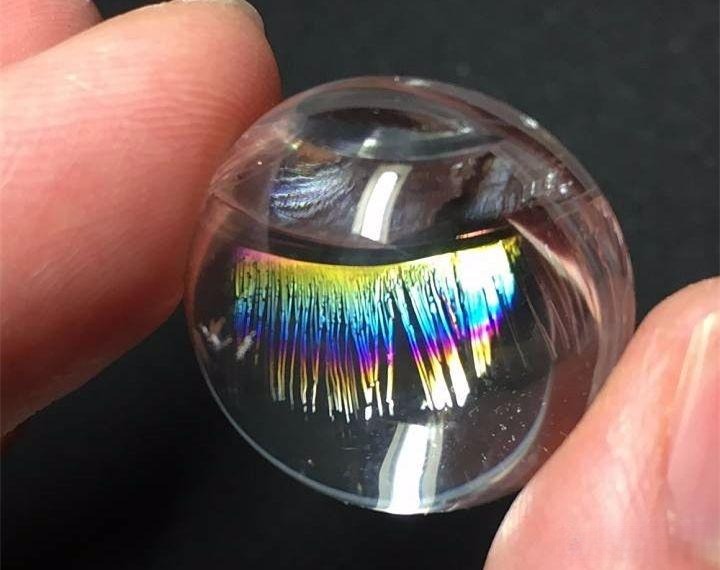Displaying rainbow lash inclusions from another angle, capturing the shifting colors and magical light effects