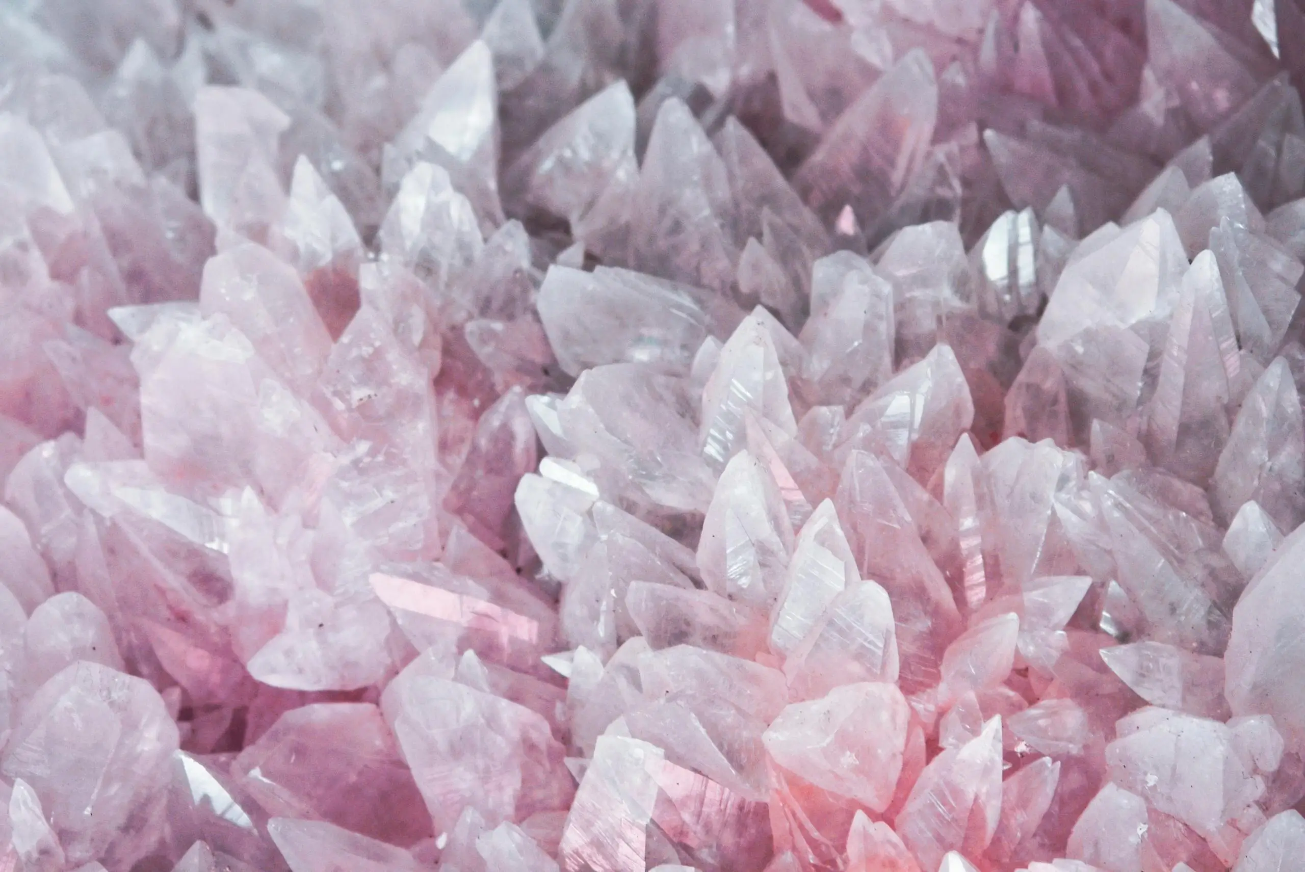 Close-up of rose quartz crystals highlighting their pink color and translucency, illustrating gemstone windowing issues.