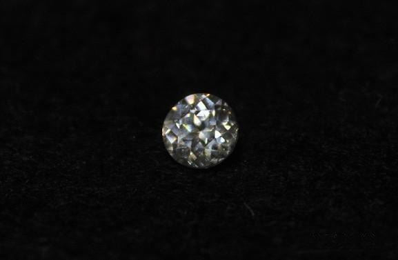 Small round faceted colorless cassiterite, a dazzling example of colorful white gemstones with sparkling brilliance and high-dispersion fire