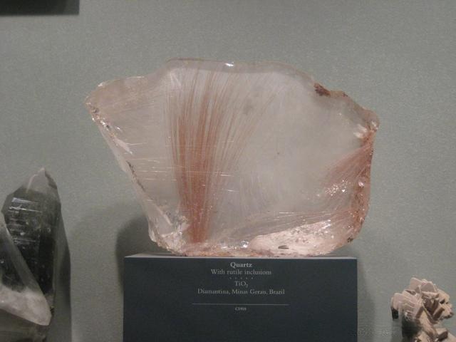 Rutile inclusions in quartz, ranging from red to orange-brown, with fire often hidden beneath the rich body color, a striking example of colorful white gemstones