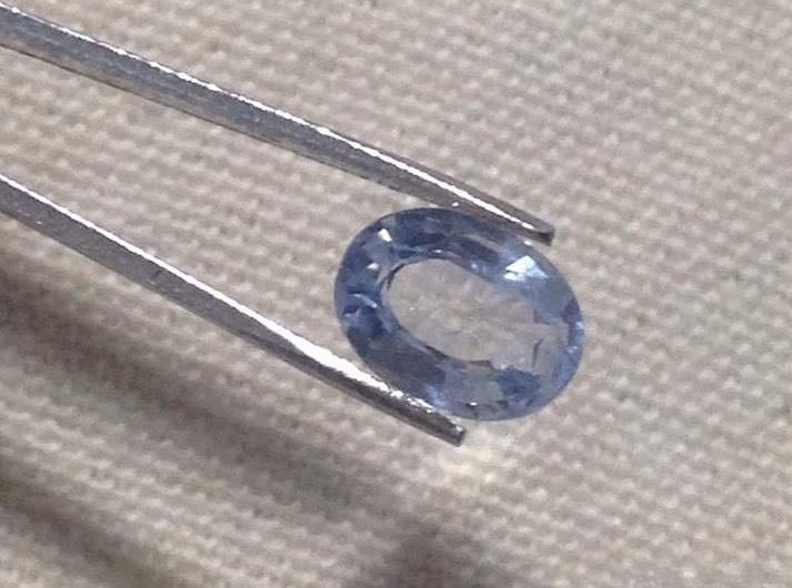 Sapphire gemstone showing a typical example of windowing, where a shallow pavilion causes reduced color saturation in part of the stone.