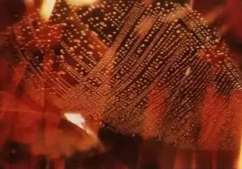 Magnified view of a Sri Lankan ruby revealing abundant fluid inclusions inside the gemstone.