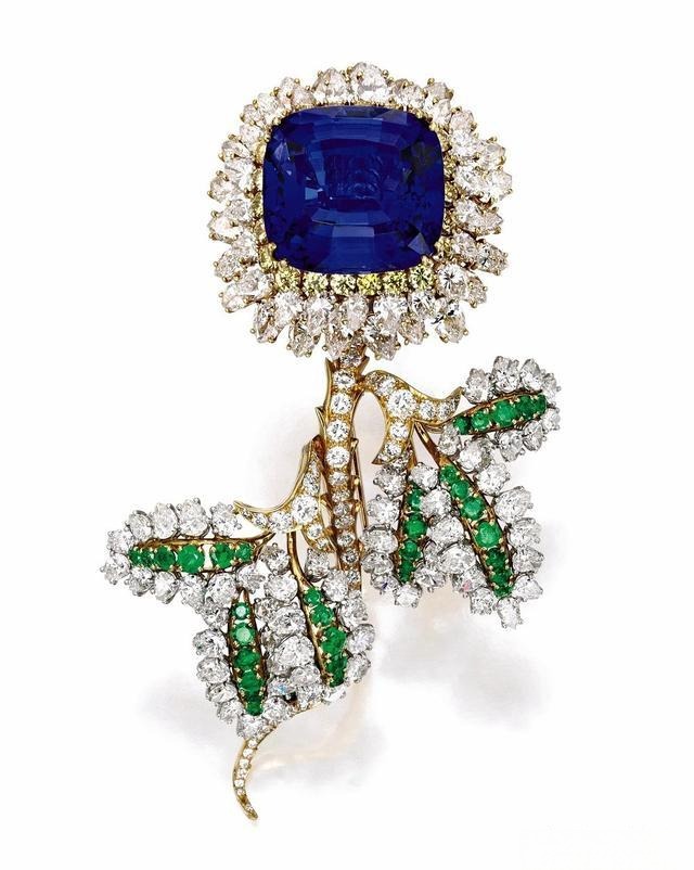 Donald Claflin designed Tiffany & Co. brooch featuring a 47.85-carat cushion-cut Tanzanite center stone, surrounded by diamonds and emeralds.