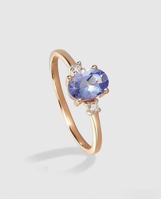 Gold ring featuring a vibrant blue stone with elegant design and fine craftsmanship