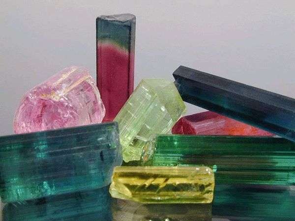 Colorful rough tourmaline crystal showing vibrant hues created by lithium, magnesium, iron, and sodium