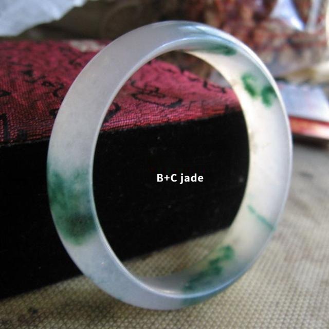 Low-quality jade bangle treated and dyed (B+C jade) to enhance color and translucency, not natural jadeite.