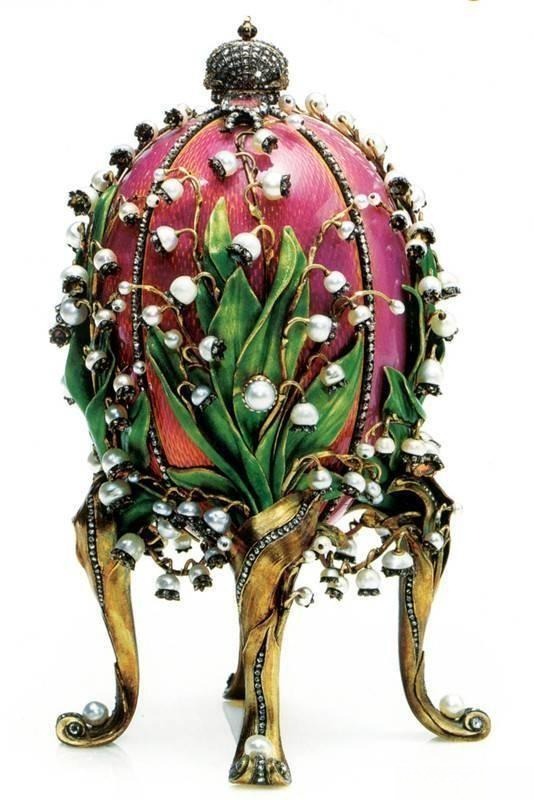 Fabergé "Valley of Hundred Flowers" egg made of translucent pink enamel, adorned with pearls, diamonds, and rubies, showcasing intricate craftsmanship.