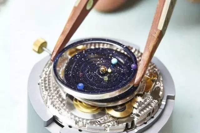 Van Cleef & Arpels planetarium watch mechanism showing miniature solar system with planets moving in real orbital periods