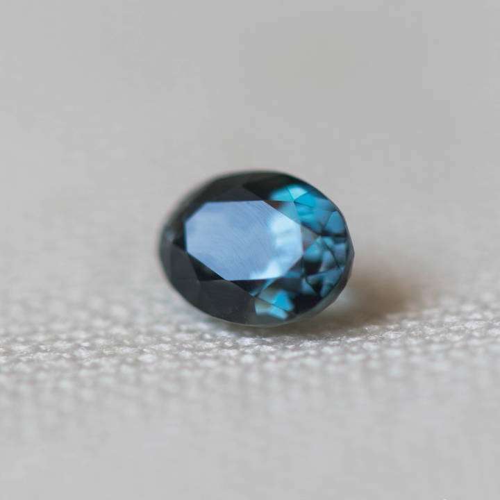 0.56 carat clean and transparent Sapphirine gemstone showing bluish-green hues