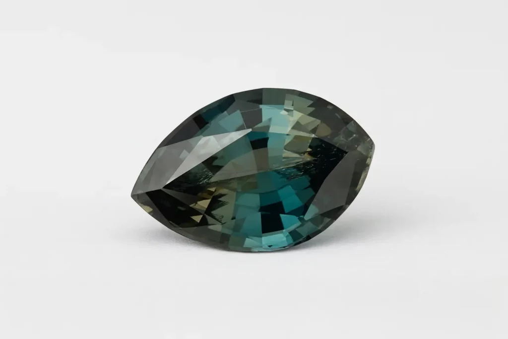 1.72 carat clean faceted Fake Sapphire showing bluish-green and pale yellow pleochroism.