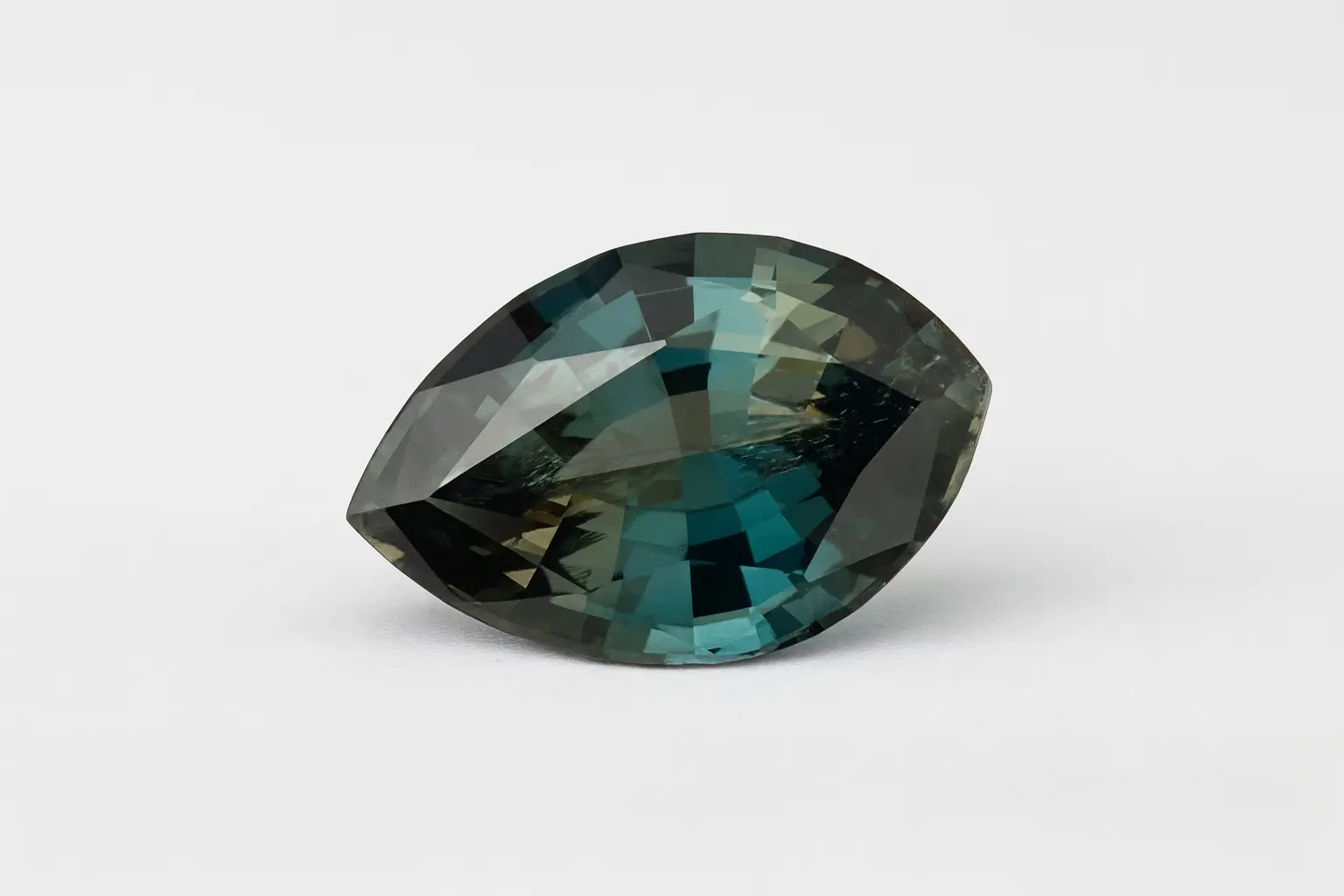 1.72 carat clean faceted Sapphirine gemstone showing bluish-green and pale yellow pleochroism.