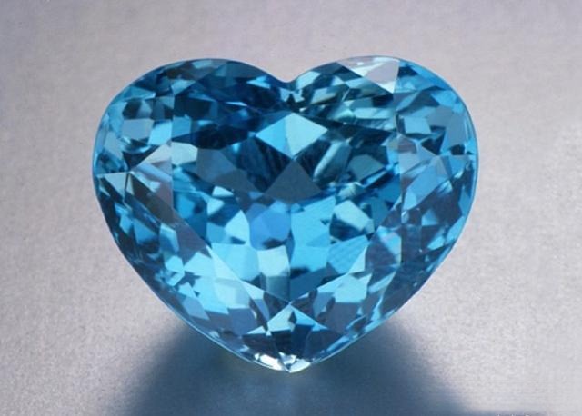A 32.1-carat heart-cut, heated beryl gemstone displaying a valuable, saturated pure blue color.