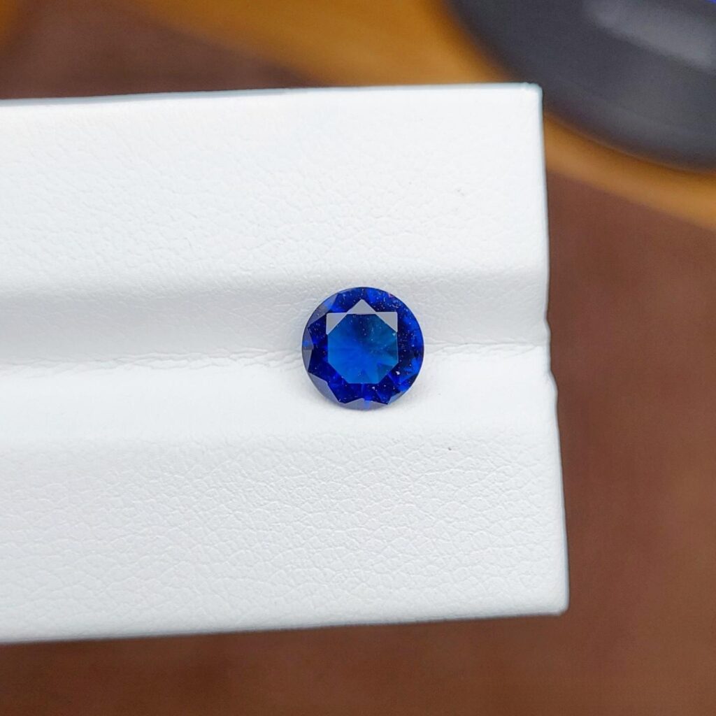 Close-up of a cobalt glass imitation gemstones sapphire, showing a strong blue color achieved by using Cobalt (Co).