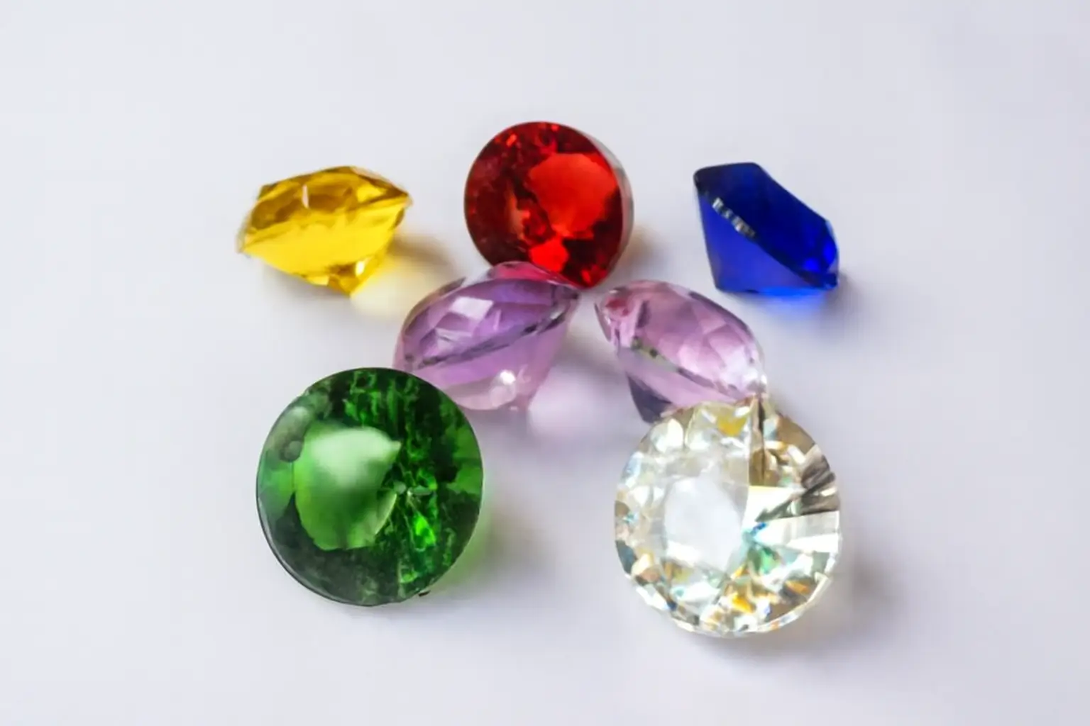 Assortment of brightly colored glass imitation gemstones (liuli), showcasing the material's ability to mimic various natural gems.