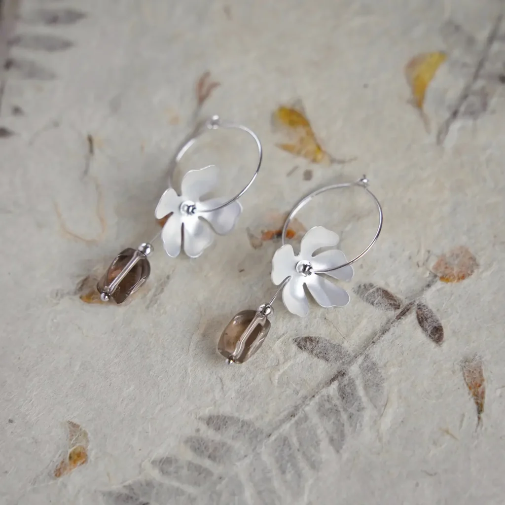 Handcrafted vintage smoky crystal hoop earrings by Jewea, featuring exquisite craftsmanship, warm translucent tones, and elegant design.