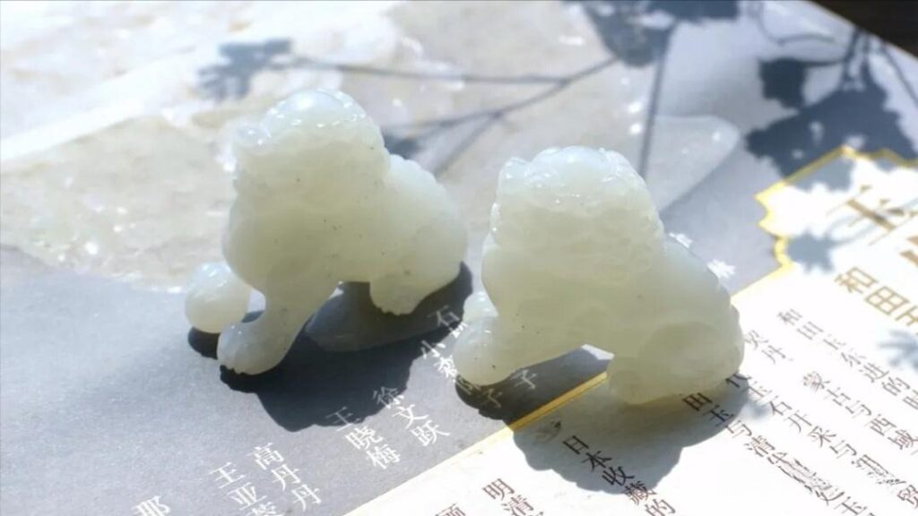 Authentic white Hetian Jade lion carvings by Jewea, illustrating the quality and buttery luster of fine nephrite.