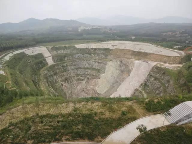 An aerial view of the Mengyin Natural Diamond Mine in China, showing the kimberlite pipe mining operation.