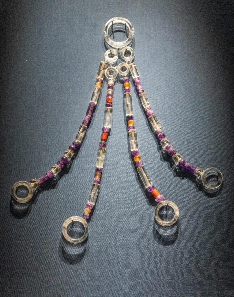 A crystal and agate pendant set used as a clothing weight (yajin), traditionally worn to secure the edges of garments.
