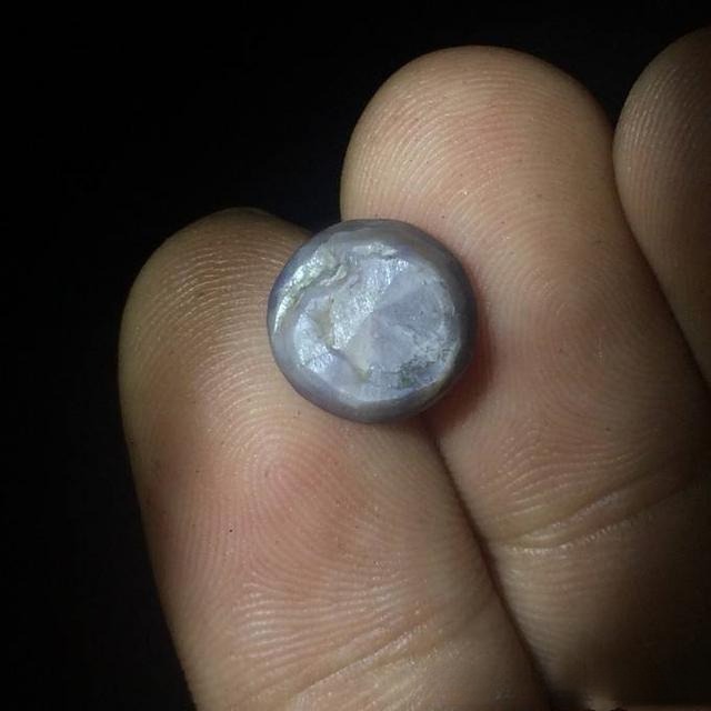 Dabiz sapphire with a rough, uneven base and visible outward-extending inclusions