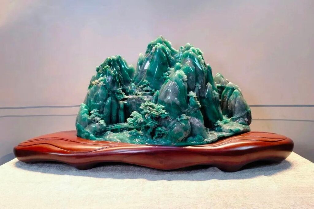 Dulong Jade carving "Holding the Treasure" showcasing intricate craftsmanship and natural green hues.