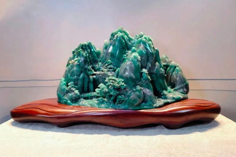 Dulong Jade Sculpture - Handcrafted decorative piece made from Dulong Jade, showcasing intricate carving and unique green inclusions.