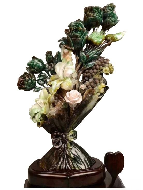 Exquisite Nanyang Dushan Jade carving of a flower bouquet, showcasing green, white, and purple colors.