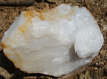 Dyed quartzite stone with vibrant color, imitating natural Hetian jade for demonstration purposes.