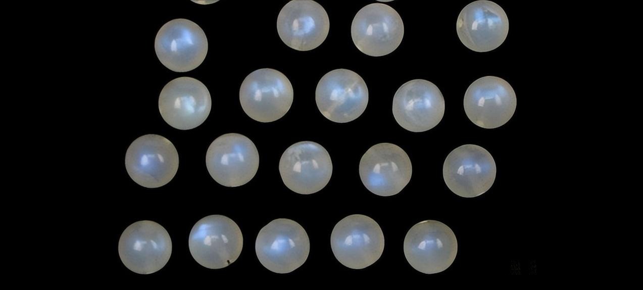 A group of moonstones treated with internal resin filling to stabilize fractures and enhance their clarity and adularescence.